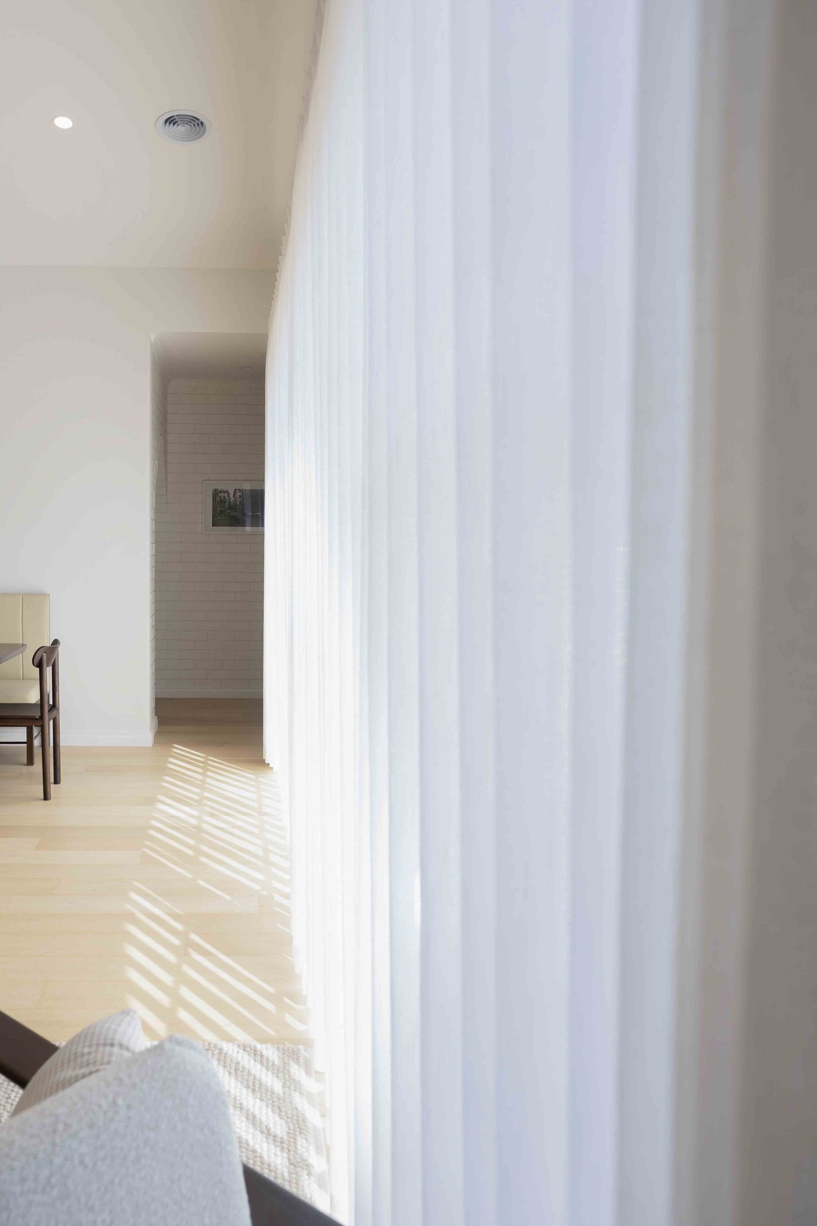 Bright room with sheer white curtains from GETC.